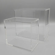 Two clear acrylic display stands on a black background