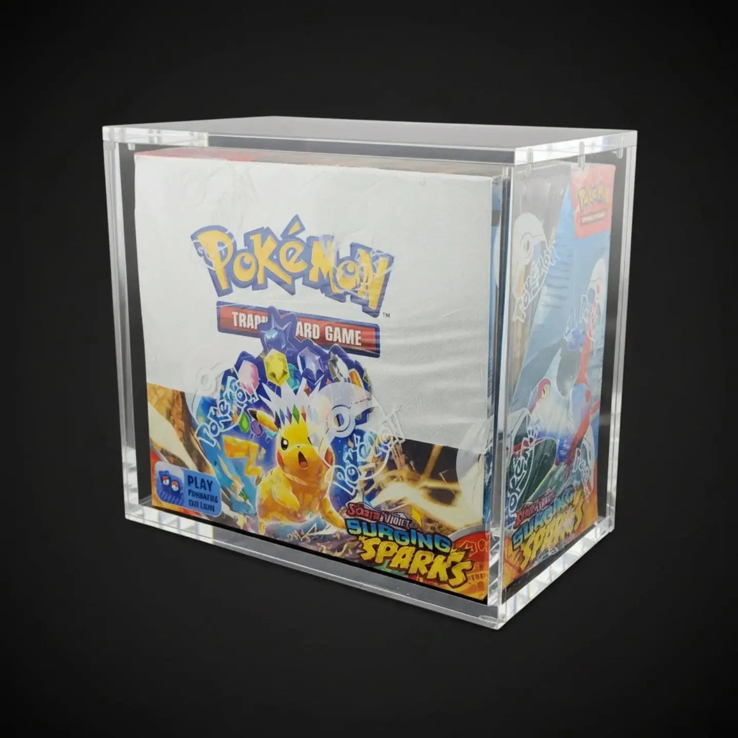 Collection of Pokémon trading cards in a clear acrylic display box on a black background